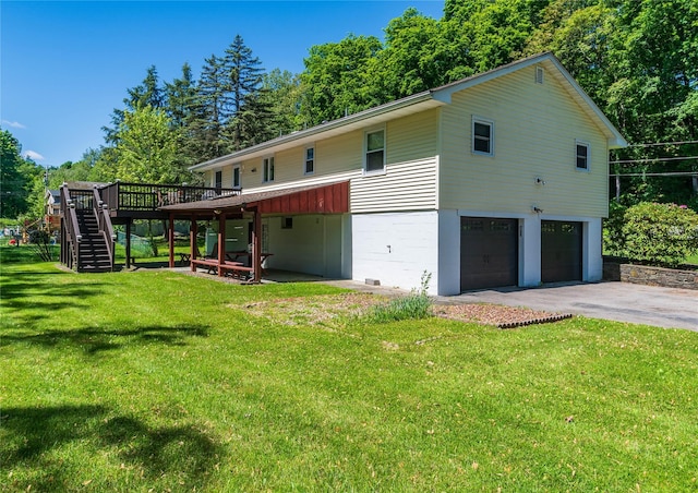 184 Cedar Valley Rd, Poughkeepsie, NY 12603 - rear view of property with stairway, a wooden deck, asphalt driveway, an attached garage, and a lawn