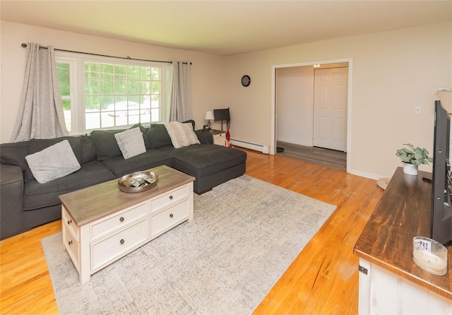 184 Cedar Valley Rd, Poughkeepsie, NY 12603 - living area with light wood-type flooring and a baseboard heating unit