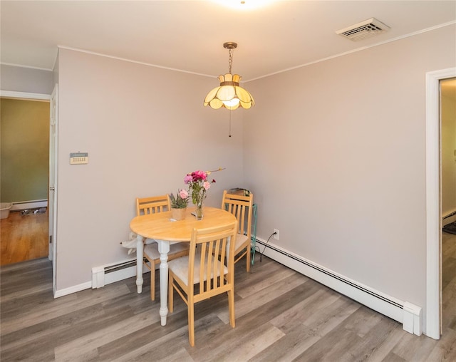184 Cedar Valley Rd, Poughkeepsie, NY 12603 - dining space with baseboard heating, wood finished floors, and ornamental molding