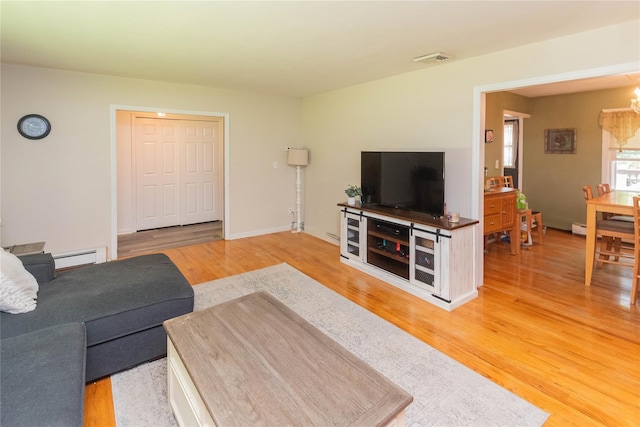 184 Cedar Valley Rd, Poughkeepsie, NY 12603 - living area with light wood-style flooring, a baseboard heating unit, and a chandelier