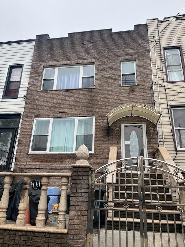 284 Hemlock St, Brooklyn, NY 11208 - view of property with brick siding and a gate