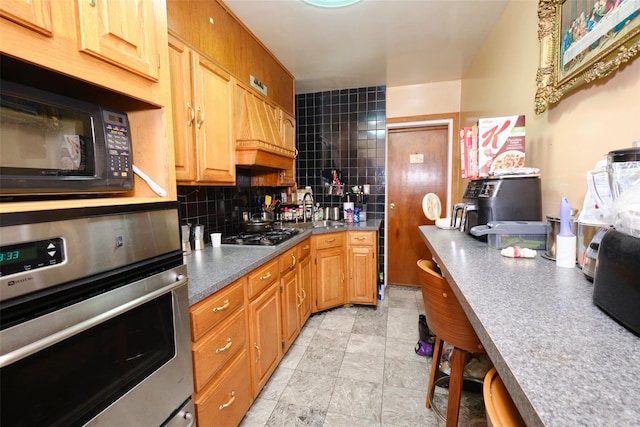 284 Hemlock St, Brooklyn, NY 11208 - kitchen featuring appliances with stainless steel finishes, a sink, decorative backsplash, and dark countertops