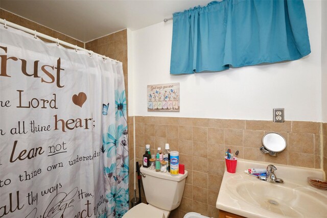284 Hemlock St, Brooklyn, NY 11208 - bathroom with toilet, tile walls, vanity, a shower with shower curtain, and wainscoting