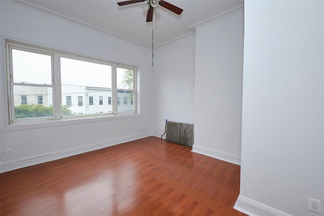 284 Hemlock St, Brooklyn, NY 11208 - spare room with radiator heating unit, crown molding, wood finished floors, a ceiling fan, and baseboards