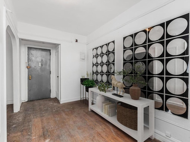 1075 Grand Concourse Unit 1N, Bronx, NY 10452 - foyer with arched walkways, wood finished floors, and baseboards