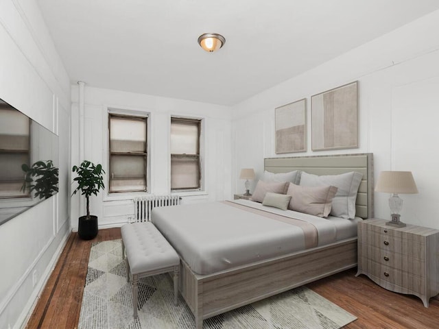 1075 Grand Concourse Unit 1N, Bronx, NY 10452 - bedroom featuring radiator and wood finished floors
