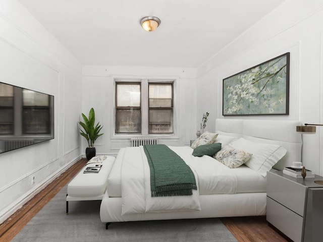 1075 Grand Concourse Unit 1N, Bronx, NY 10452 - bedroom featuring wood finished floors and radiator heating unit