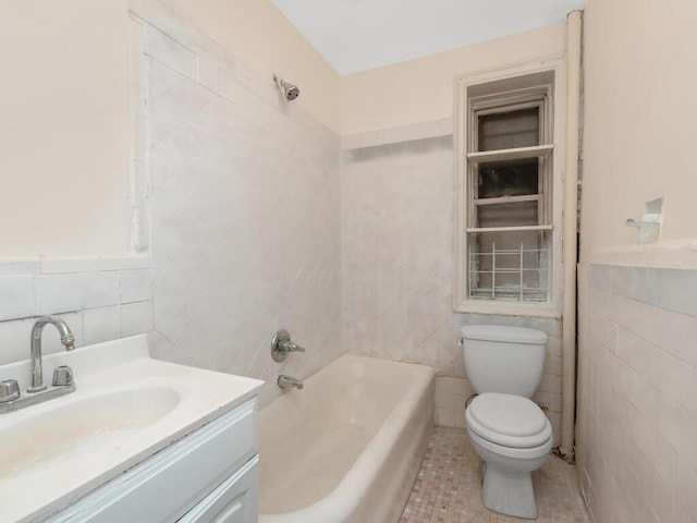 1075 Grand Concourse Unit 1N, Bronx, NY 10452 - full bath with tile walls, toilet, vanity, tile patterned flooring, and tub / shower combination
