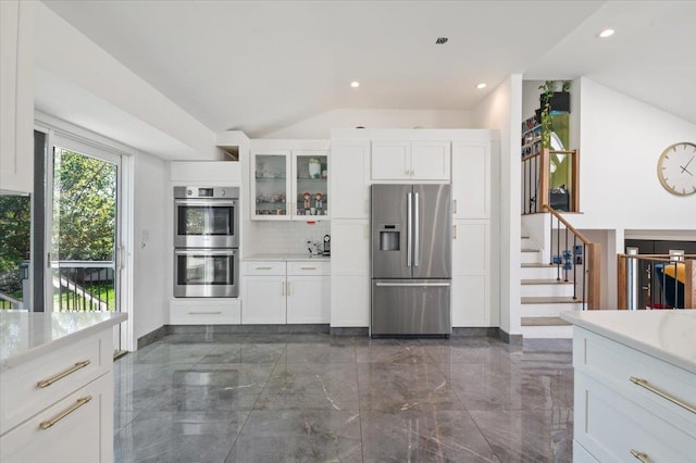 862 Fanwood Ave, North Woodmere, NY 11581 - kitchen featuring appliances with stainless steel finishes, dark marble finish floors, baseboards, glass insert cabinets, and vaulted ceiling