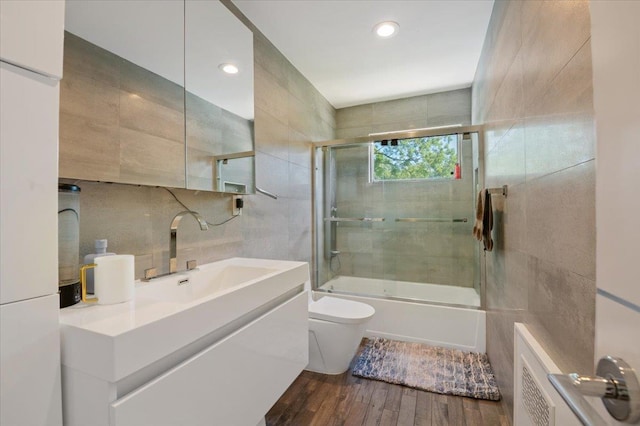 862 Fanwood Ave, North Woodmere, NY 11581 - full bath featuring tile walls, wood finished floors, toilet, enclosed tub / shower combo, and vanity