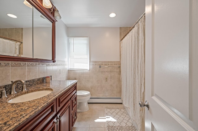 full bath featuring a baseboard heating unit, tile patterned flooring, tile walls, toilet, and vanity