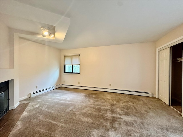 8 Ebury, Middletown, NY 10940 - unfurnished living room with a fireplace with flush hearth, baseboards, a baseboard radiator, and dark carpet