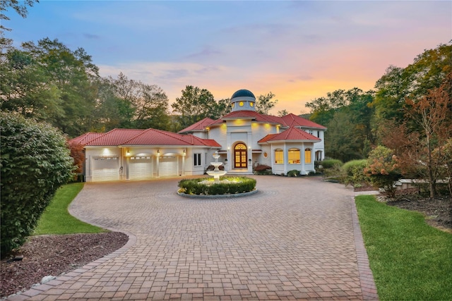 652 Haverstraw Rd, Suffern, NY 10901 - mediterranean / spanish-style house with curved driveway, french doors, an attached garage, and stucco siding