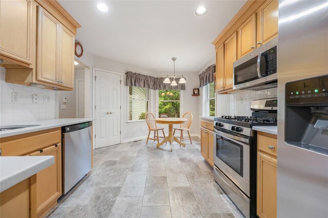 701 Pheasant Woods Rd, Briarcliff Manor, NY 10510 - kitchen with stainless steel appliances, a chandelier, light countertops, decorative backsplash, and baseboards