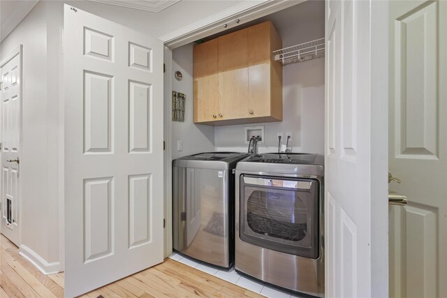 701 Pheasant Woods Rd, Briarcliff Manor, NY 10510 - clothes washing area featuring independent washer and dryer, cabinet space, and light wood-type flooring