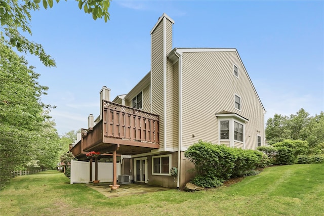 701 Pheasant Woods Rd, Briarcliff Manor, NY 10510 - rear view of property with a chimney, a lawn, central AC unit, and a deck
