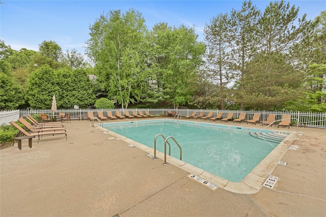 701 Pheasant Woods Rd, Briarcliff Manor, NY 10510 - community pool with fence, a patio area, and view of wooded area
