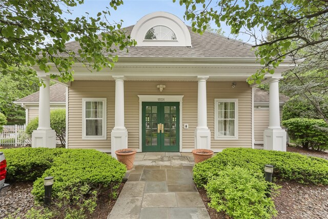 701 Pheasant Woods Rd, Briarcliff Manor, NY 10510 - neoclassical home featuring french doors, roof with shingles, a porch, and fence