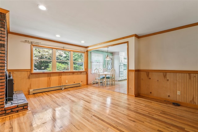 359 Old Bridge Rd, East Northport, NY 11731 - spare room with a baseboard radiator, wainscoting, crown molding, hardwood / wood-style floors, and wood walls