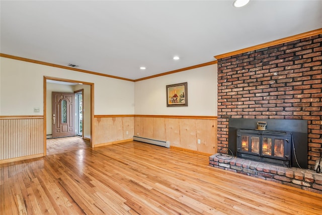 359 Old Bridge Rd, East Northport, NY 11731 - unfurnished living room featuring hardwood / wood-style flooring, a baseboard heating unit, a wainscoted wall, crown molding, and a brick fireplace