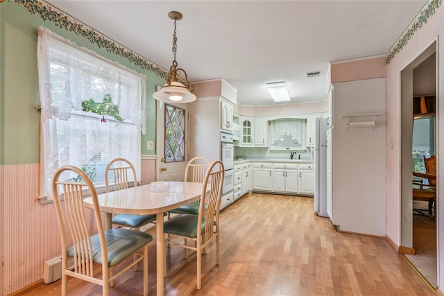 359 Old Bridge Rd, East Northport, NY 11731 - dining space featuring light wood-style flooring and wainscoting