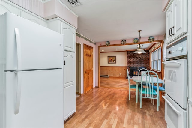 359 Old Bridge Rd, East Northport, NY 11731 - kitchen featuring white appliances, white cabinets, light wood-type flooring, a warming drawer, and a wainscoted wall