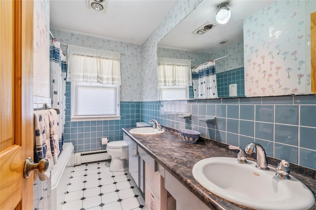 359 Old Bridge Rd, East Northport, NY 11731 - bathroom featuring wallpapered walls, a baseboard heating unit, a wainscoted wall, tile walls, and toilet