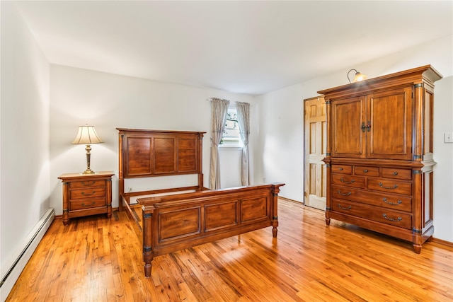 359 Old Bridge Rd, East Northport, NY 11731 - bedroom with a baseboard radiator and light wood-style floors