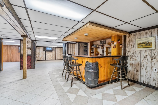 359 Old Bridge Rd, East Northport, NY 11731 - indoor dry bar featuring wooden walls, a paneled ceiling, baseboards, and light tile patterned flooring