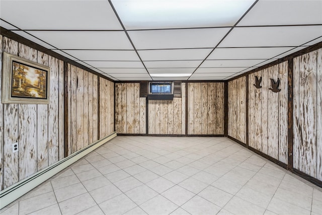 359 Old Bridge Rd, East Northport, NY 11731 - finished basement with baseboard heating, a paneled ceiling, wooden walls, and baseboards