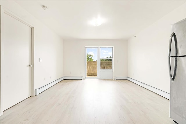 9305 37th Ave Unit 3D, Jackson Heights, NY 11372 - spare room featuring light wood finished floors, a baseboard heating unit, a smoke detector, and a baseboard radiator