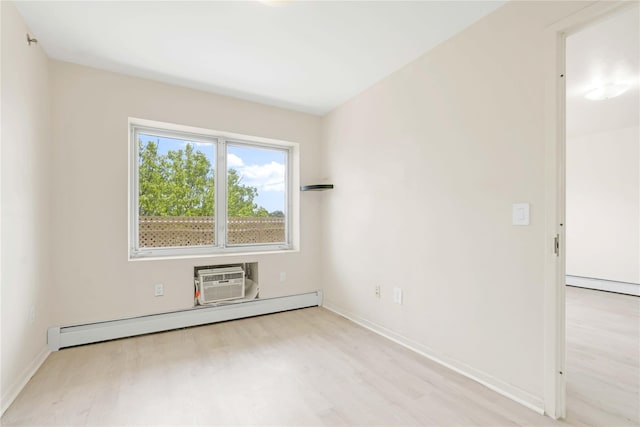 9305 37th Ave Unit 3D, Jackson Heights, NY 11372 - spare room featuring a baseboard heating unit, wood finished floors, a wall mounted air conditioner, and baseboards