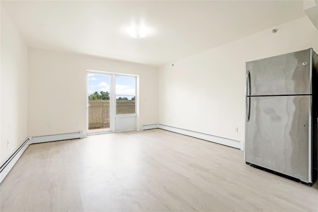 9305 37th Ave Unit 3D, Jackson Heights, NY 11372 - spare room with baseboard heating, light wood-style flooring, and baseboards