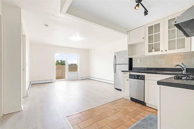 9305 37th Ave Unit 3D, Jackson Heights, NY 11372 - kitchen with appliances with stainless steel finishes, exhaust hood, dark countertops, tasteful backsplash, and light wood finished floors
