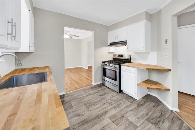105 Colgate Ave, Yonkers, NY 10703 - kitchen featuring wooden counters, stainless steel range with gas cooktop, a sink, under cabinet range hood, and light wood-style flooring