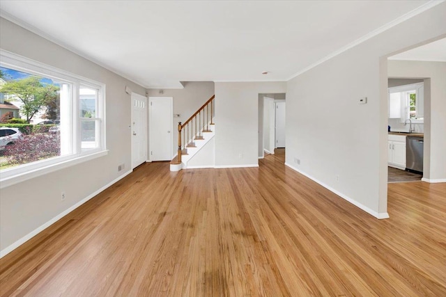 105 Colgate Ave, Yonkers, NY 10703 - unfurnished living room featuring healthy amount of natural light, light wood finished floors, and stairway