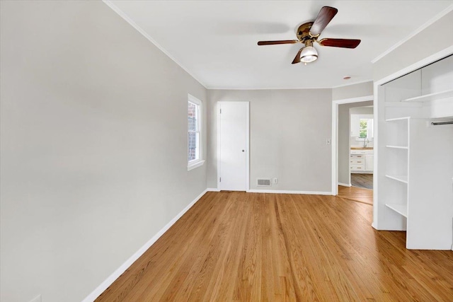 105 Colgate Ave, Yonkers, NY 10703 - unfurnished living room featuring light wood-style floors, plenty of natural light, ornamental molding, ceiling fan, and baseboards