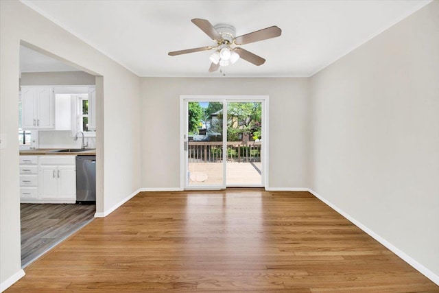 105 Colgate Ave, Yonkers, NY 10703 - unfurnished room featuring a sink, a ceiling fan, light wood-style flooring, and baseboards