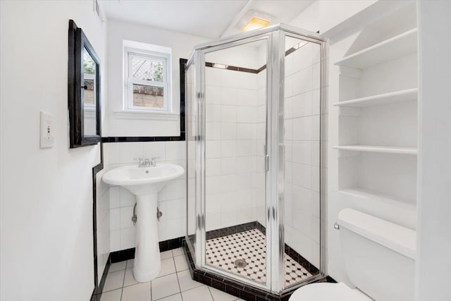 105 Colgate Ave, Yonkers, NY 10703 - full bath with toilet, a shower stall, tile patterned floors, tile walls, and a sink