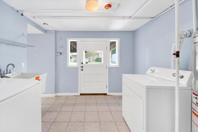 105 Colgate Ave, Yonkers, NY 10703 - laundry room with baseboards, washer and clothes dryer, and light tile patterned floors