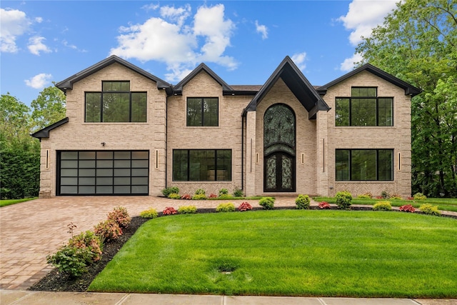 46 Snapdragon Ln, Roslyn Heights, NY 11577 - view of front of home featuring an attached garage, brick siding, a front yard, driveway, and french doors