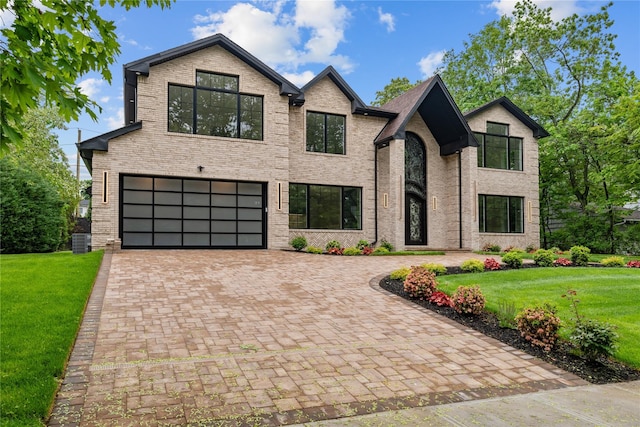 46 Snapdragon Ln, Roslyn Heights, NY 11577 - view of front facade with an attached garage, decorative driveway, a front lawn, and central AC