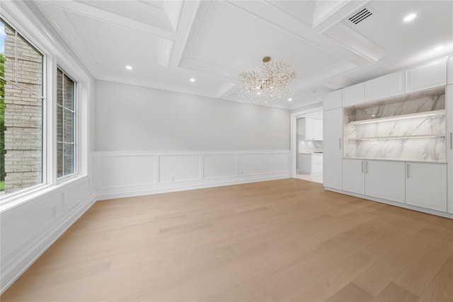 46 Snapdragon Ln, Roslyn Heights, NY 11577 - spare room featuring light wood-style floors, coffered ceiling, a chandelier, wainscoting, and recessed lighting