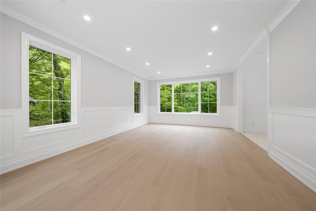 46 Snapdragon Ln, Roslyn Heights, NY 11577 - empty room with a decorative wall, wainscoting, and light wood-style flooring