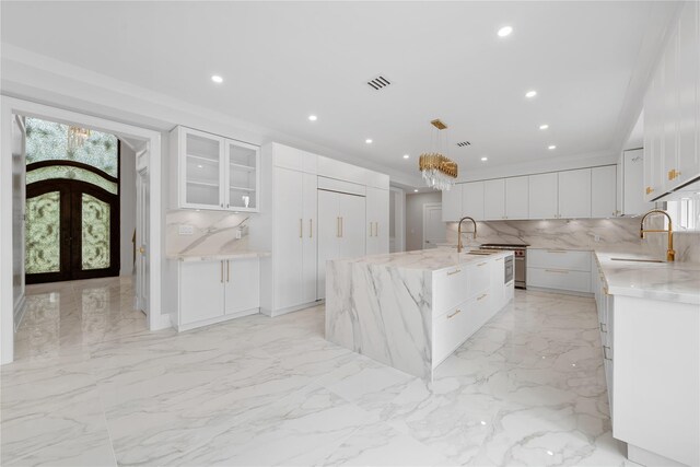 46 Snapdragon Ln, Roslyn Heights, NY 11577 - kitchen featuring a sink, light marble finish flooring, tasteful backsplash, french doors, and recessed lighting