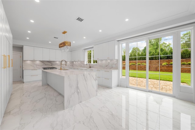 46 Snapdragon Ln, Roslyn Heights, NY 11577 - kitchen featuring decorative backsplash, light marble finish flooring, white cabinets, recessed lighting, and ornamental molding