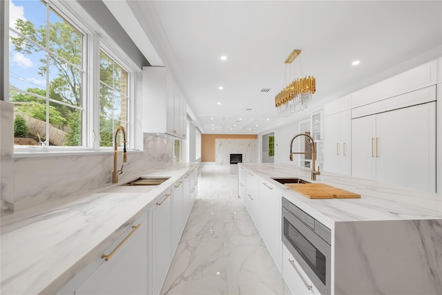 46 Snapdragon Ln, Roslyn Heights, NY 11577 - kitchen with a sink, stainless steel microwave, modern cabinets, and recessed lighting