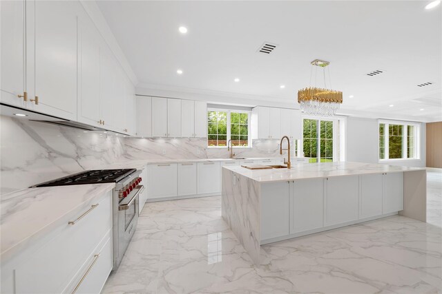 46 Snapdragon Ln, Roslyn Heights, NY 11577 - kitchen featuring stainless steel stove, tasteful backsplash, light marble finish flooring, a large island, and white cabinetry