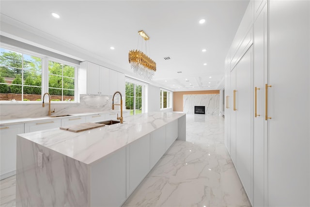 46 Snapdragon Ln, Roslyn Heights, NY 11577 - kitchen with a sink, recessed lighting, light marble finish floors, and white cabinetry