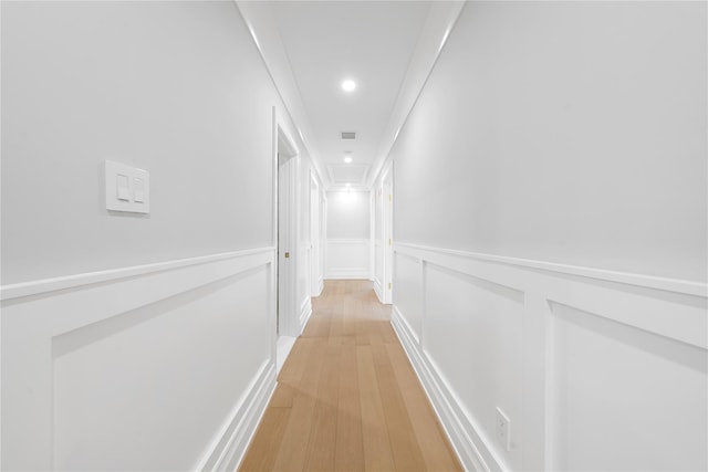 46 Snapdragon Ln, Roslyn Heights, NY 11577 - hall featuring light wood-style flooring, attic access, recessed lighting, a wainscoted wall, and a decorative wall
